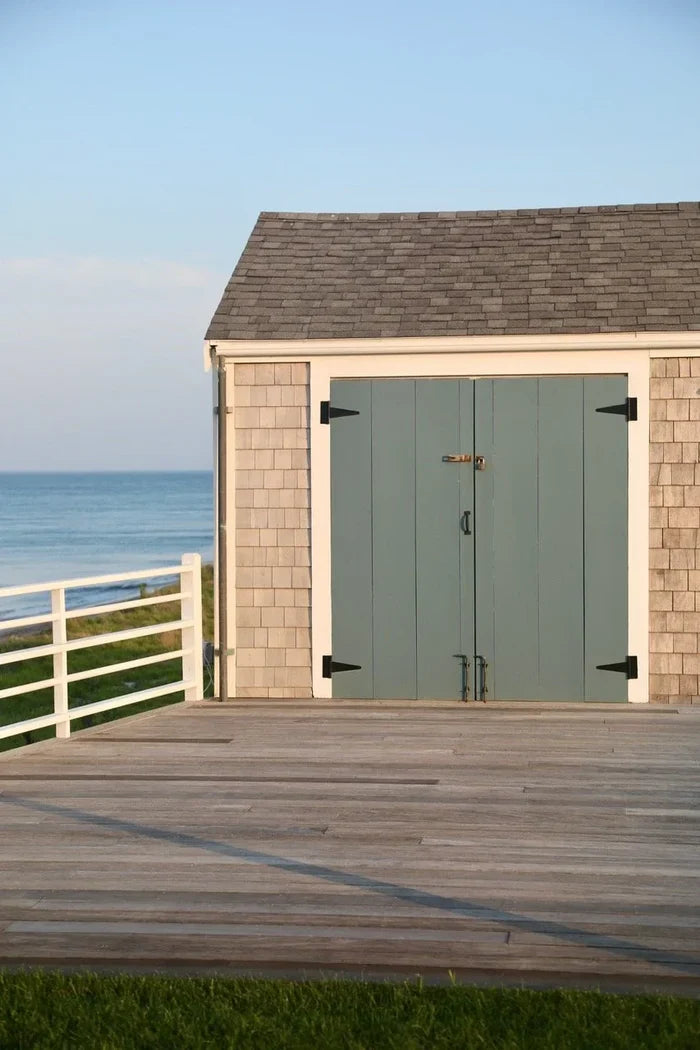 Shed with a wooden deck overlooking a body of water