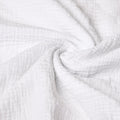 Close-up of white textured muslin fabric