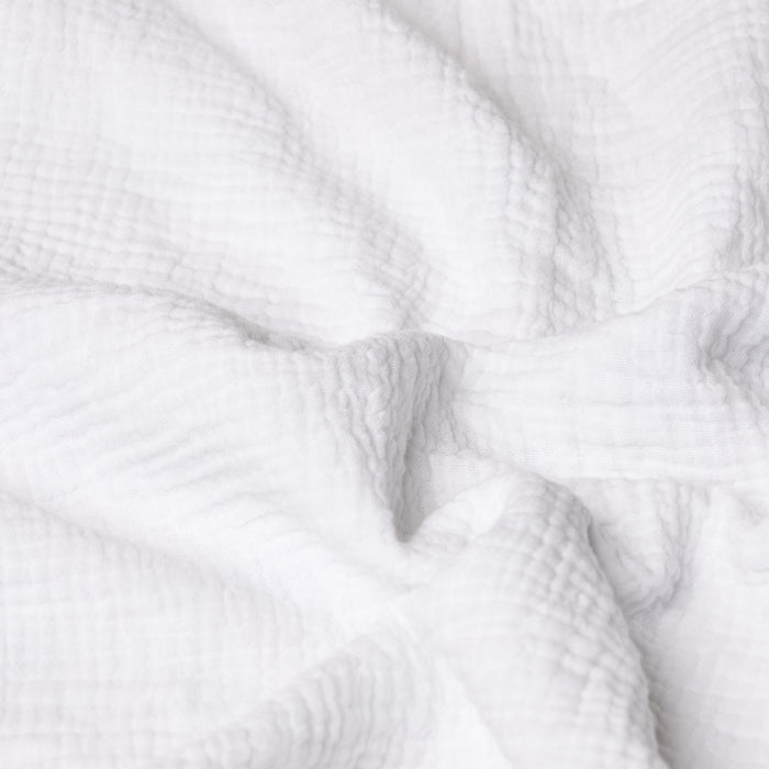 Close-up of white textured muslin fabric