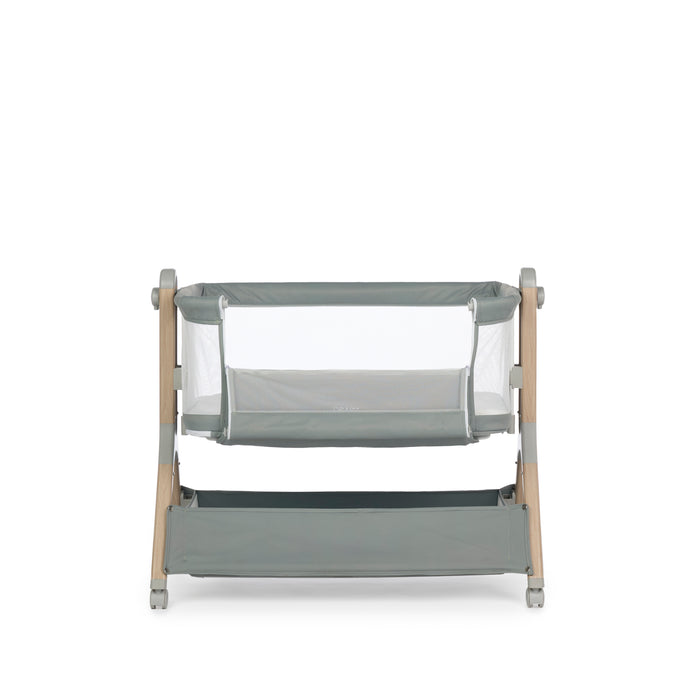 Sage bedside crib with wood effect frame,  showing the side panel is unzipped.